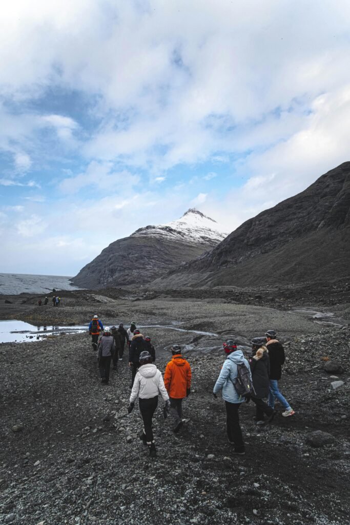 Group of hikers trekking through the rugged and scenic landscapes of Iceland.