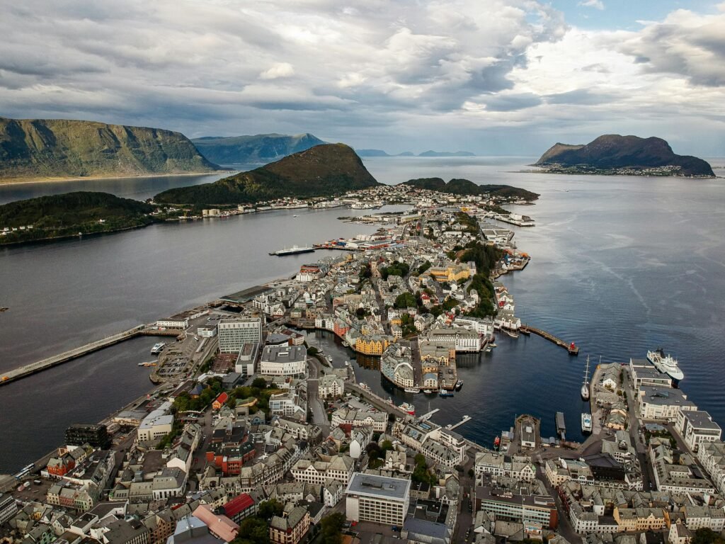 Stunning aerial view of Ålesund, Norway, showcasing its coastal cityscape and surrounding mountains.