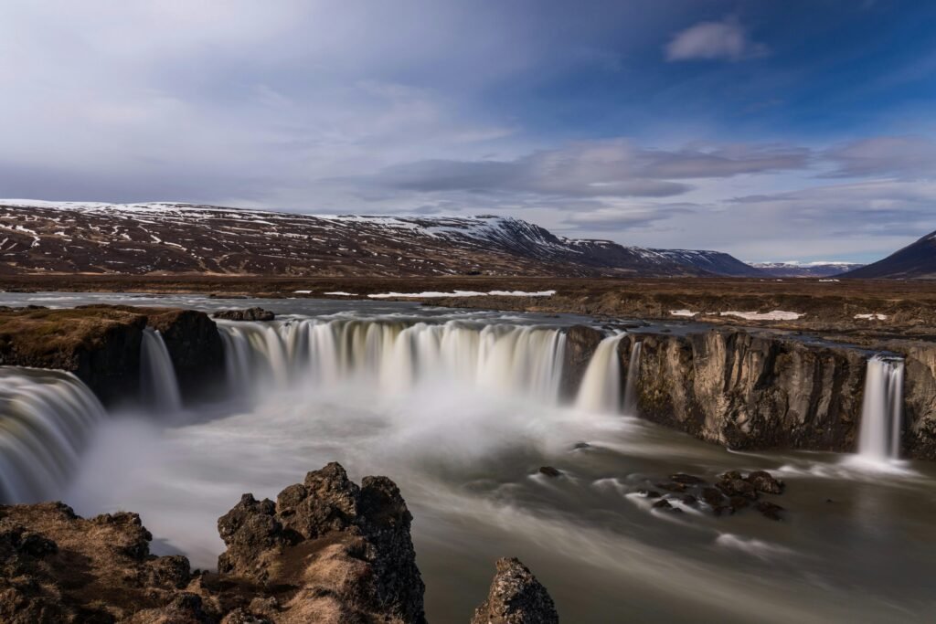 Explore the breathtaking Godafoss Waterfall, a stunning natural landmark in Iceland's rugged landscape.