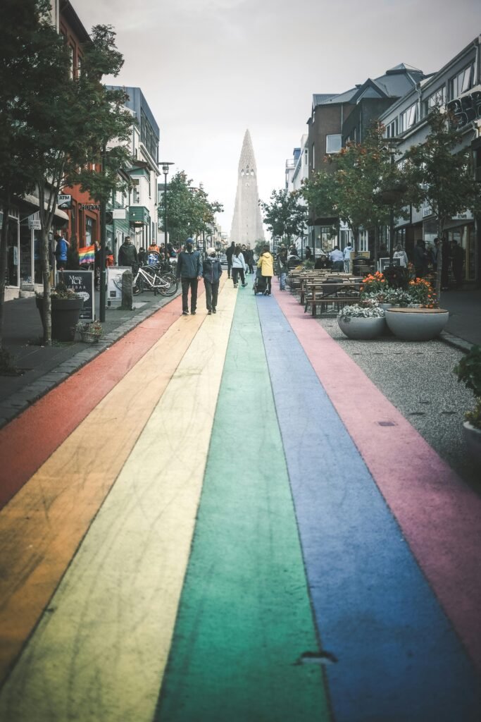 Colorful street in Reykjavik leading to Hallgrímskirkja, capturing urban life.