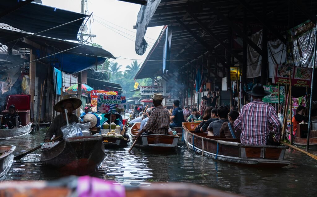 Vibrant floating market with boats full of people shopping and trading goods.