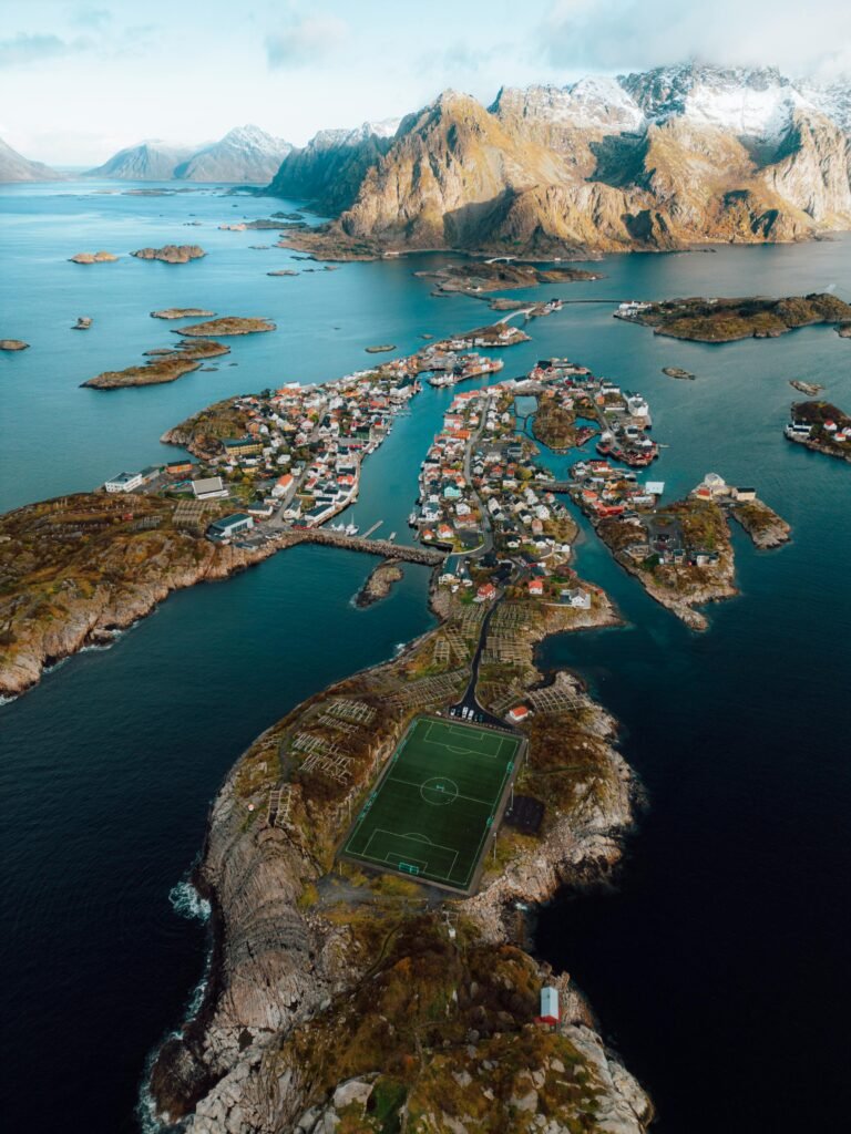 Stunning aerial view of Henningsvær Stadium amidst the fjords of Norway.