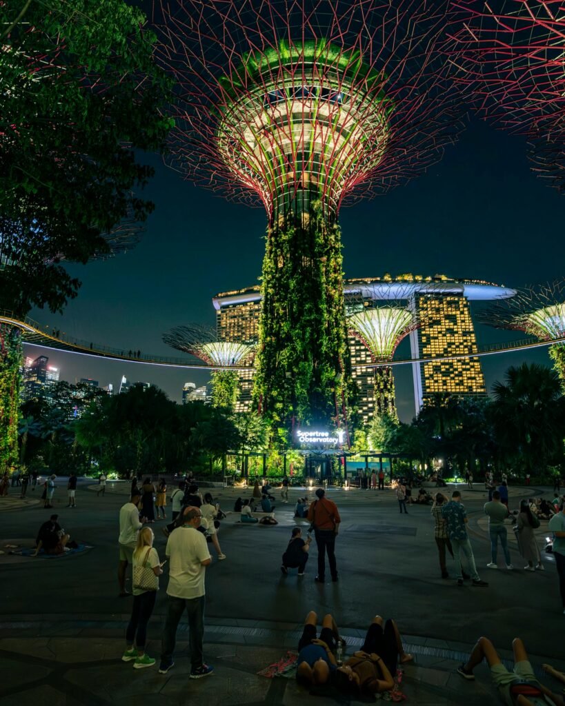 Vibrant night scene at Gardens by the Bay, Singapore with iconic Supertree structures.