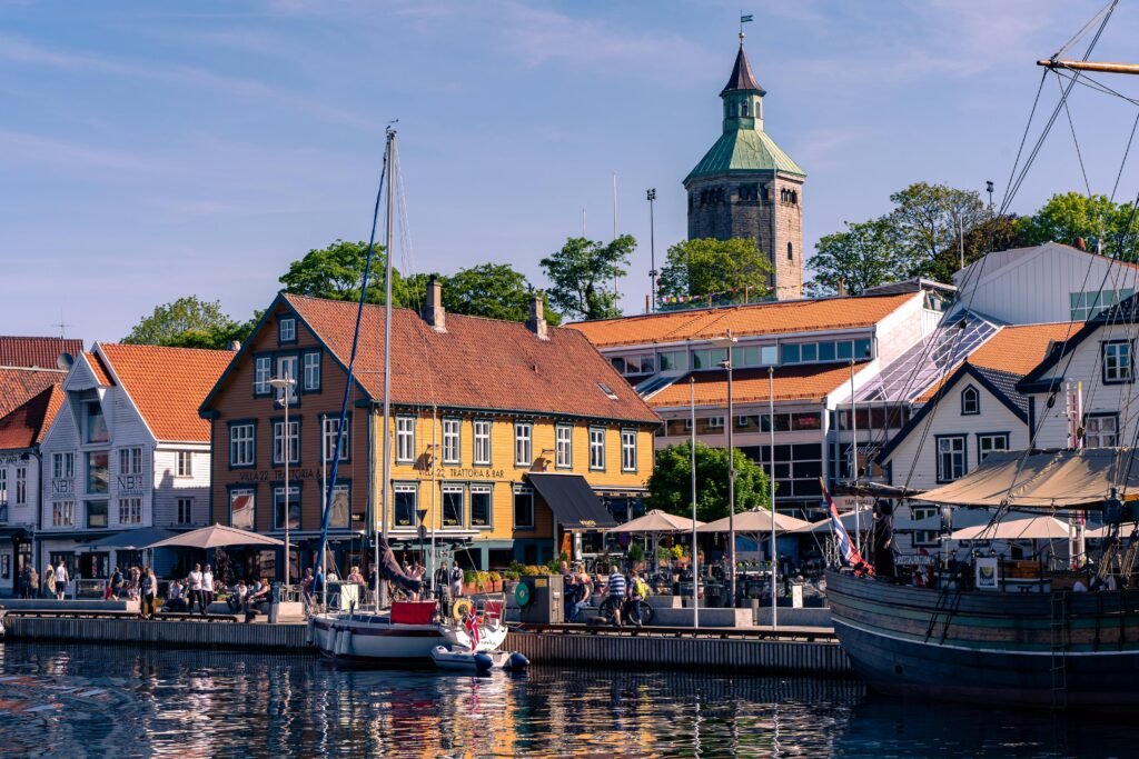 Vibrant summer day at the Stavanger waterfront with colorful buildings and boats.