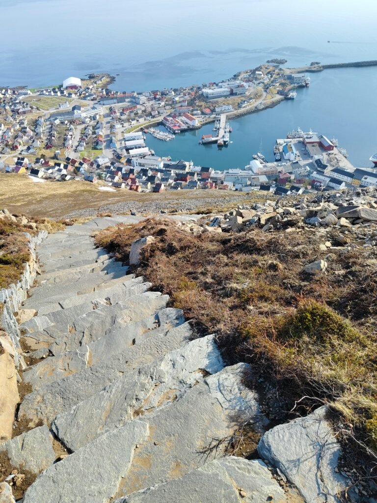 Explore Honningsvåg harbor from the iconic Nordkapp stairway in this vibrant elevated photo.