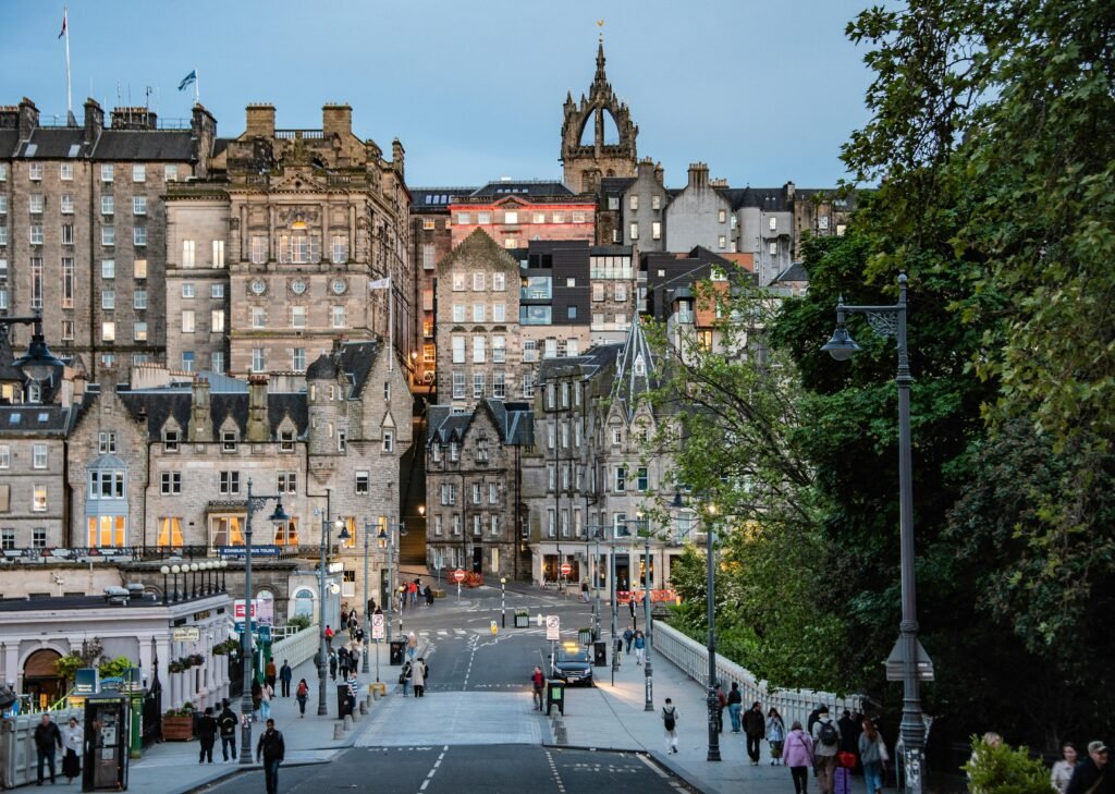 Charming view of Edinburgh's Old Town with pedestrians on a bustling street.
