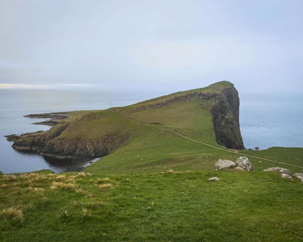 Breathtaking coastal landscape of Neist Point, showcasing dramatic cliffs and serene seas at dusk.