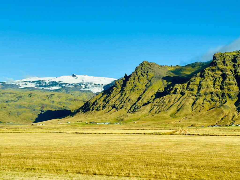 Discover the breathtaking beauty of Iceland's majestic mountain landscapes under clear blue skies.