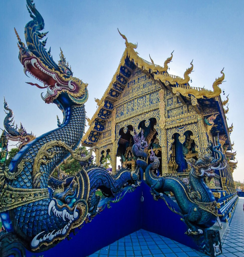 Ornate architectural details of the Blue Temple in Chiang Rai with vibrant dragon motifs.
