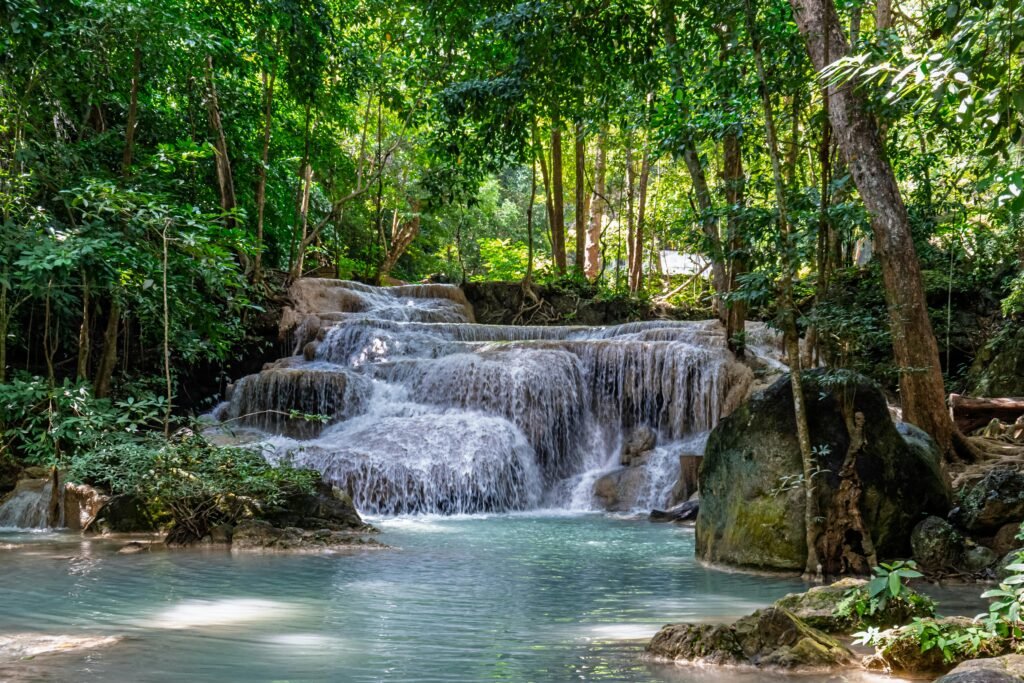 Discover tranquility with this lush tropical waterfall flowing through verdant forest scenery.