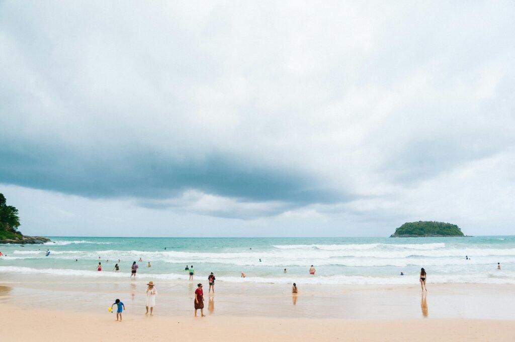 Relaxing day at Kata Beach, Phuket with people enjoying the ocean and beautiful scenery.
