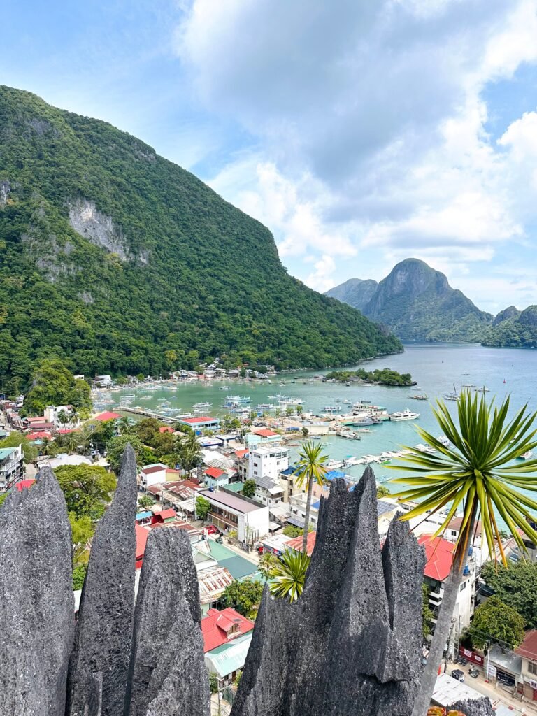 A stunning aerial view of El Nido's harbor and surrounding lush mountains in Palawan, Philippines.