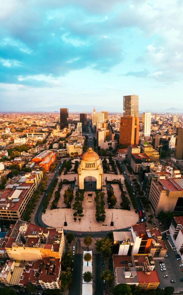 Stunning aerial shot of Mexico City's skyline with the iconic Revolution Monument in the foreground.