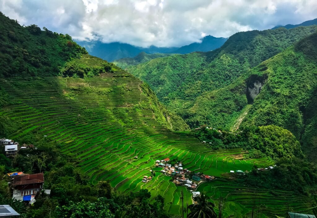 A breathtaking aerial shot of Banaue's iconic rice terraces under sunlight.